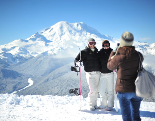 Skiers taking a photo with Rainier in the background