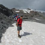 Man with baby in carrier on snow at Paradise Glacier
