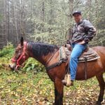 Veteran and member of Project Refit on a horse during a guided trail ride in Elbe
