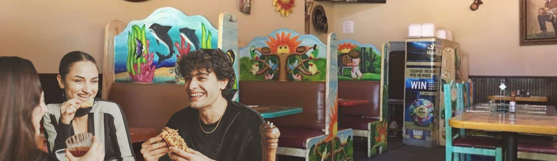 Photo of three people eating Mexican food. Image for use on El Reconsito landing page