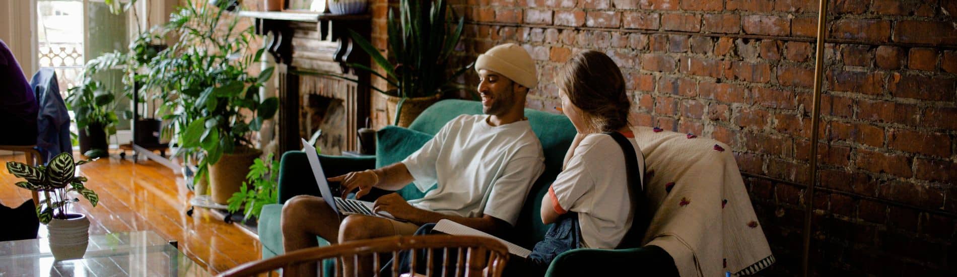 Two people sit on a couch in Wellhouse Café Buckley